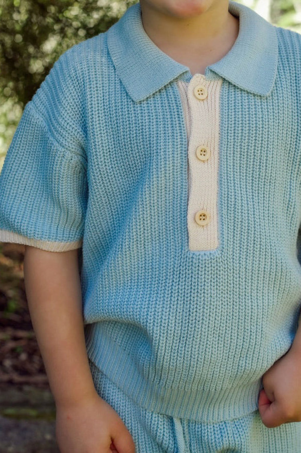 Toddler wearing the Willow Set in Heirloom Blue — boys' 100% organic cotton knit two-piece with oat detailing