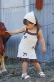 Toddler wearing the Colette Dress in Chestnut & Creme — 100% organic cotton knit dress with bow detail