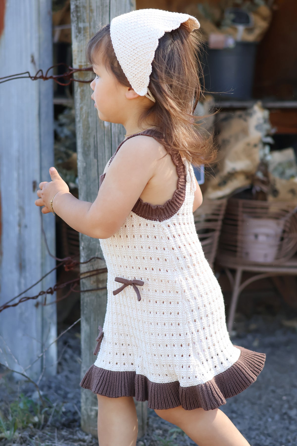 Toddler wearing the Colette Dress in Chestnut & Creme — 100% organic cotton knit dress with bow detail