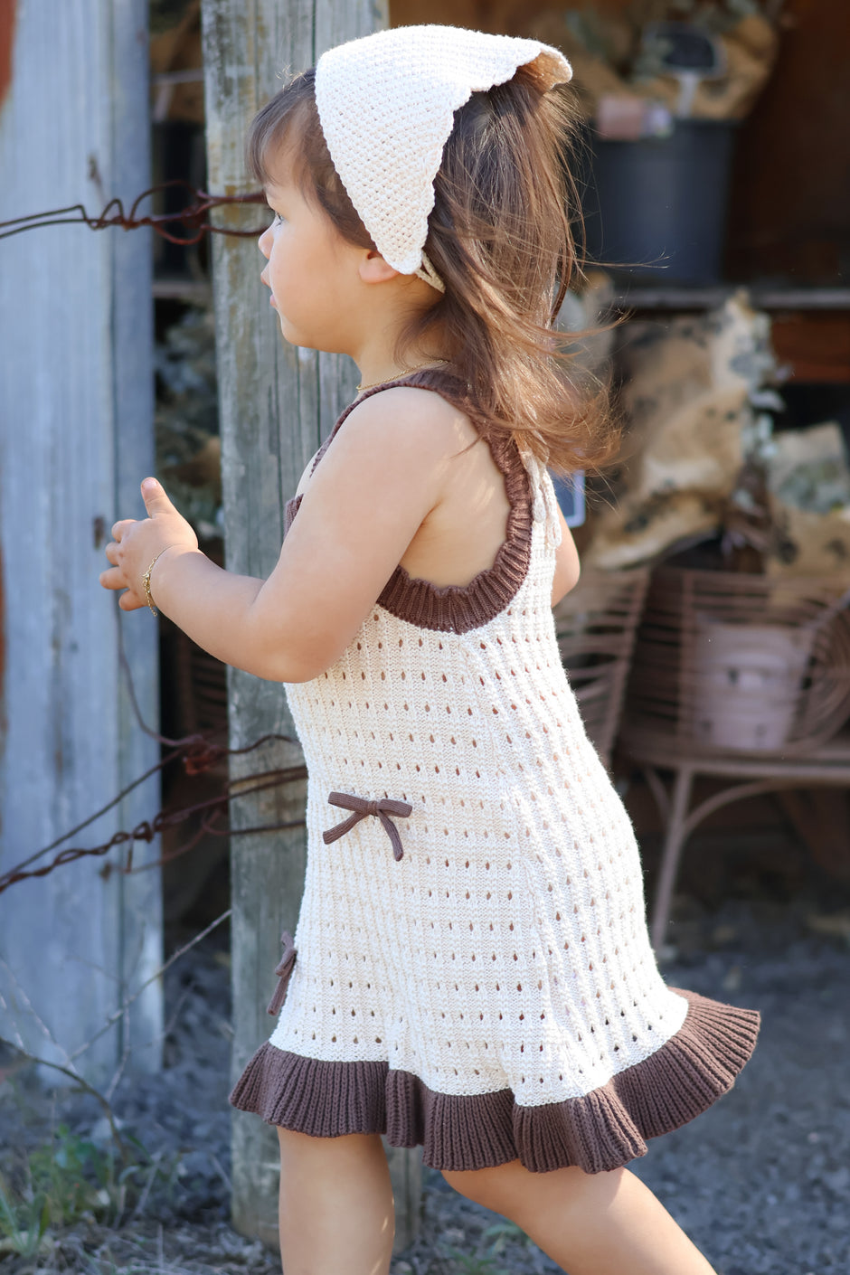 Toddler wearing the Colette Dress in Chestnut & Creme — 100% organic cotton knit dress with bow detail