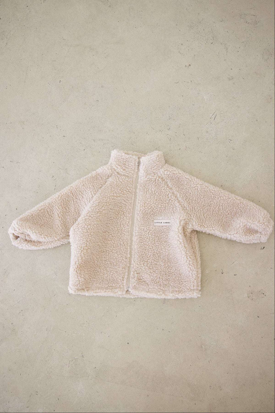 Beige fleece jacket on a beige background
