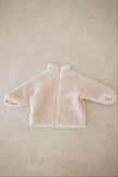 Beige fleece jacket on a beige background