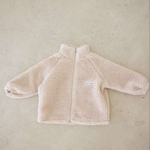 Beige fleece jacket on a beige background