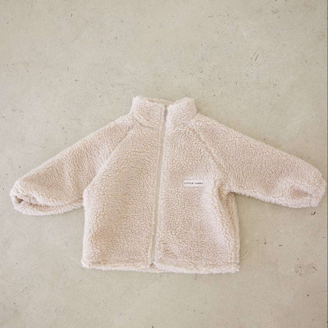 Beige fleece jacket on a beige background