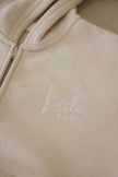 Beige hoodie with 'Little Label' embroidery on a beige background